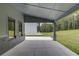 Relaxing covered patio featuring stone column bases, with a concrete floor and windows overlooking a green backyard at 37 Deer Canyon Dr, Auburn, GA 30011