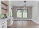 Dining area featuring large windows with views, a contemporary light fixture, and built-in cabinets at 37 Deer Canyon Dr, Auburn, GA 30011