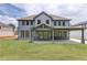 Back exterior of a two-story gray home with a covered patio, and a spacious green yard at 37 Deer Canyon Dr, Auburn, GA 30011