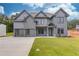 Stunning two-story home with a three-car garage and a well-maintained front yard at 37 Deer Canyon Dr, Auburn, GA 30011