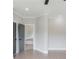 Bright hallway features a modern gray door, light hardwood floors, and neutral walls, exuding contemporary elegance at 37 Deer Canyon Dr, Auburn, GA 30011