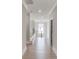 Bright hallway featuring hardwood floors, white trim, and an open staircase with wood railing at 37 Deer Canyon Dr, Auburn, GA 30011