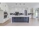 Modern kitchen with white cabinets, stainless steel appliances, and a large island with a marble countertop at 37 Deer Canyon Dr, Auburn, GA 30011