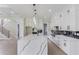 Open concept kitchen with island featuring white marble countertops and stylish lighting at 37 Deer Canyon Dr, Auburn, GA 30011