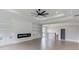 Spacious living room with custom built-ins, fireplace, and tray ceiling with fan at 37 Deer Canyon Dr, Auburn, GA 30011