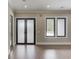 Bright living room featuring hardwood floors, large windows and modern accents at 37 Deer Canyon Dr, Auburn, GA 30011