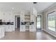 Open space with kitchen cabinets and workspace with outdoor views from the patio door and large window at 37 Deer Canyon Dr, Auburn, GA 30011