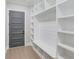 Mud room featuring custom shelves, bench seating, and a hardwood floor at 37 Deer Canyon Dr, Auburn, GA 30011