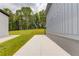 Side yard features a long concrete walkway bordered by green grass, leading to a spacious backyard and mature trees at 37 Deer Canyon Dr, Auburn, GA 30011