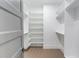 Walk-in closet with custom shelves and hardwood flooring at 37 Deer Canyon Dr, Auburn, GA 30011