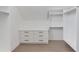 Bright walk-in closet with built-in shelving, drawers, and light wood flooring at 37 Deer Canyon Dr, Auburn, GA 30011