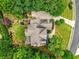Overhead view of home with a deck, patio, landscaping, and a circular driveway at 9035 Brixham Ct, Suwanee, GA 30024