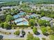 Aerial view of community amenities featuring multiple tennis courts and a luxurious swimming pool and clubhouse at 9035 Brixham Ct, Suwanee, GA 30024