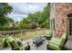 Inviting back deck with comfortable seating and a serene view of the lush, landscaped backyard at 9035 Brixham Ct, Suwanee, GA 30024