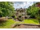 Beautiful brick home featuring an entertainment deck in the private, landscaped backyard at 9035 Brixham Ct, Suwanee, GA 30024