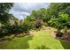 Expansive backyard featuring lush green lawn and meticulously maintained landscaping at 9035 Brixham Ct, Suwanee, GA 30024