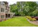 Lush backyard with mature trees and landscaping, offering privacy and a serene outdoor space at 9035 Brixham Ct, Suwanee, GA 30024
