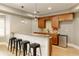 Basement bar features stone countertops, wood cabinets, tiled backsplash and stainless steel mini fridge at 9035 Brixham Ct, Suwanee, GA 30024