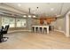 Open basement includes a bar area with countertop seating, cabinetry, and stainless steel mini fridge at 9035 Brixham Ct, Suwanee, GA 30024