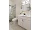 Modern bathroom features a white vanity, framed mirror, and a glass-enclosed shower with marble tile at 9035 Brixham Ct, Suwanee, GA 30024