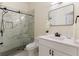 Modern bathroom features a white vanity, framed mirror, and a glass-enclosed shower with marble tile at 9035 Brixham Ct, Suwanee, GA 30024