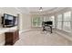Bedroom area with desk, chair, and a large window provides natural light and pleasant view at 9035 Brixham Ct, Suwanee, GA 30024