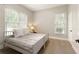 Cozy bedroom featuring hardwood floors, natural light, and neutral paint, creating a warm and inviting space at 9035 Brixham Ct, Suwanee, GA 30024