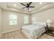 A well-lit bedroom with a ceiling fan and neutral carpet at 9035 Brixham Ct, Suwanee, GA 30024