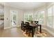 Inviting breakfast nook featuring natural light, wooden table, seating for four, and access to outdoor living at 9035 Brixham Ct, Suwanee, GA 30024