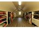 Walk-in closet with custom shelving and rods providing ample storage for clothing and accessories at 9035 Brixham Ct, Suwanee, GA 30024