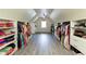 Spacious walk-in closet with custom shelving and rods providing ample storage for clothing and accessories at 9035 Brixham Ct, Suwanee, GA 30024