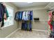 Walk-in closet featuring ample hanging space and built-in shelving for optimal organization at 9035 Brixham Ct, Suwanee, GA 30024