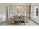 Bright dining room with wainscoting, chandelier, and a large window at 9035 Brixham Ct, Suwanee, GA 30024
