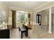 A dining room with a modern light fixture, wooden table, and elegant decor at 9035 Brixham Ct, Suwanee, GA 30024