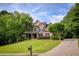 Beautiful two-story home with brick accents, mature trees, and a well-kept lawn at 9035 Brixham Ct, Suwanee, GA 30024