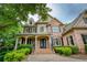 Stately brick home with a covered front porch and elegant glass front doors at 9035 Brixham Ct, Suwanee, GA 30024