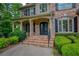 Close up of the front porch with brick steps, iron railings, and decorative front doors at 9035 Brixham Ct, Suwanee, GA 30024