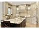 Beautiful kitchen featuring custom cabinets, stainless steel appliances, and a center island at 9035 Brixham Ct, Suwanee, GA 30024