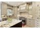 Beautiful gourmet kitchen with custom cabinetry, granite countertops, stainless steel appliances, and a center island at 9035 Brixham Ct, Suwanee, GA 30024