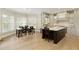 Open kitchen with custom cabinets, large island, stainless appliances, and breakfast nook with lots of natural light at 9035 Brixham Ct, Suwanee, GA 30024