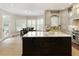 Beautiful gourmet kitchen featuring custom cabinets, granite countertops, stainless steel appliances, and a large center island at 9035 Brixham Ct, Suwanee, GA 30024