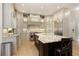 Gourmet kitchen featuring custom cabinets, granite countertops, stainless steel appliances, and large center island with barstool seating at 9035 Brixham Ct, Suwanee, GA 30024