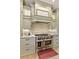 Close up of a gourmet kitchen featuring custom cabinets, granite counters, stainless steel appliances and decorative backsplash at 9035 Brixham Ct, Suwanee, GA 30024
