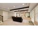 Open concept living room features coffered ceilings, exposed beams and natural light at 9035 Brixham Ct, Suwanee, GA 30024