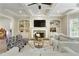 Spacious living room with fireplace, built-ins, and plenty of natural light at 9035 Brixham Ct, Suwanee, GA 30024