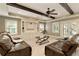Spacious living room with coffered ceiling, exposed beams, built-in shelving, and walk-out access at 9035 Brixham Ct, Suwanee, GA 30024
