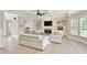 Bright living room featuring a fireplace, built-in shelving, and large windows at 9035 Brixham Ct, Suwanee, GA 30024