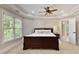 Bright bedroom with a king bed and an ensuite bathroom, with natural light and neutral colors at 9035 Brixham Ct, Suwanee, GA 30024