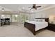 Spacious bedroom with bay windows, ceiling fan, and a king-sized bed with neutral bedding at 9035 Brixham Ct, Suwanee, GA 30024