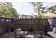 Cozy fenced backyard with string lights, mature trees, and an inviting seating area at 13 Ivy Ne Sq, Atlanta, GA 30342